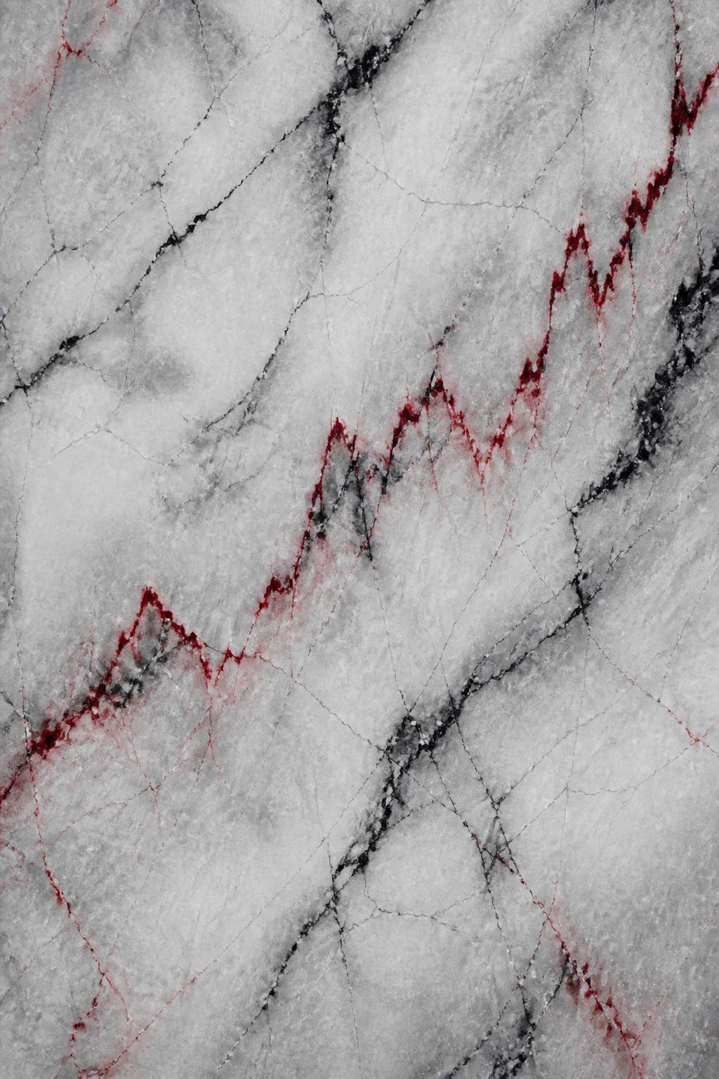 Light grey marble crossed by black and red chart-like mineral streaks